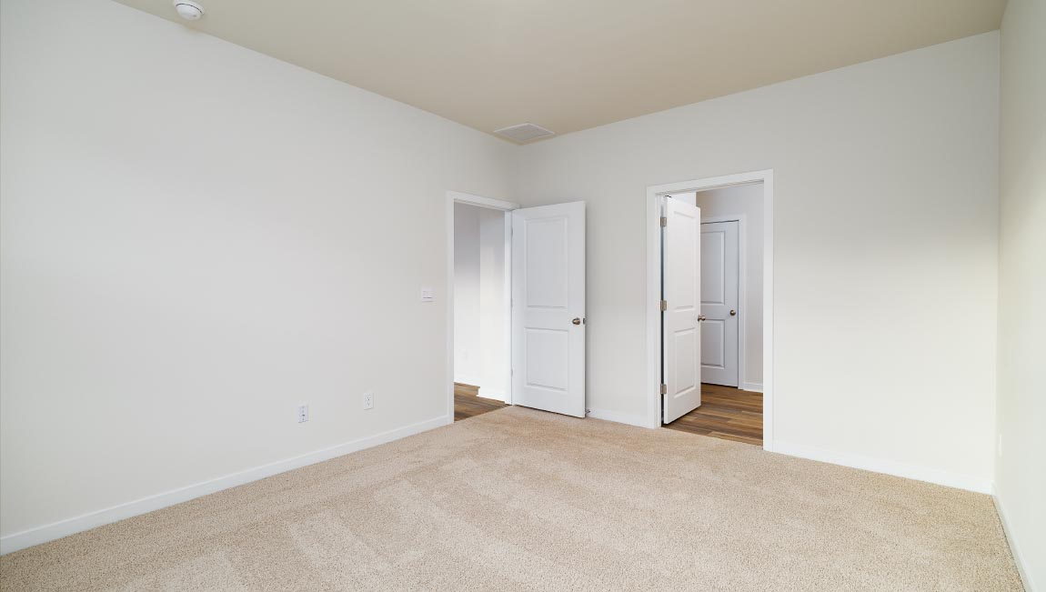 carpeted bedroom with large window