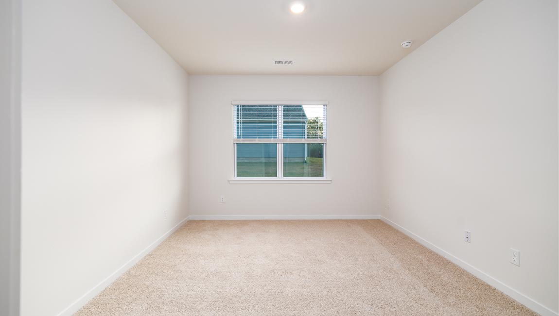 carpeted bedroom with large window