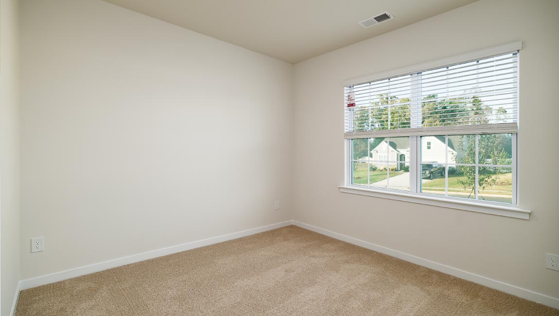 carpeted bedroom with large window