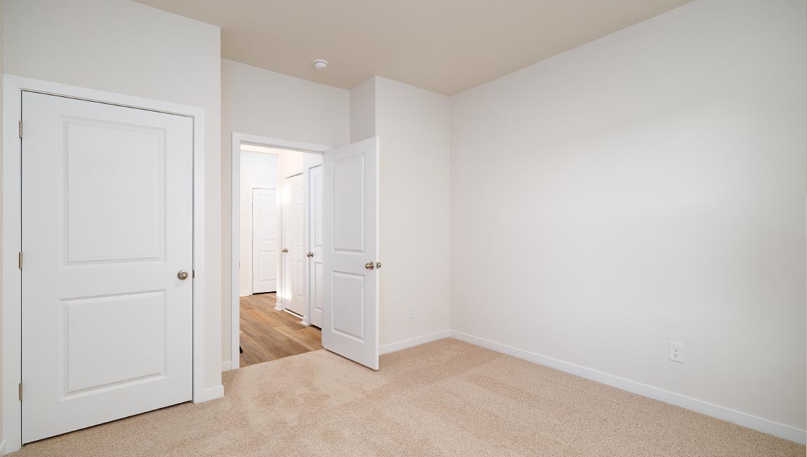 carpeted bedroom with large window