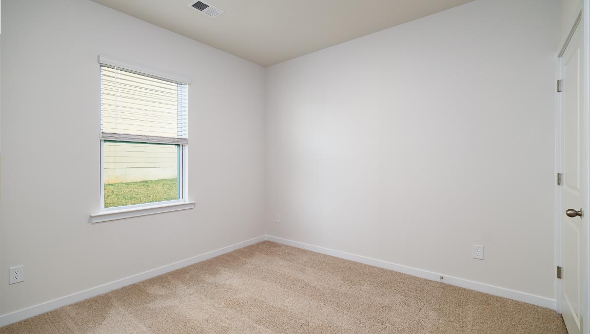 carpeted bedroom with large window