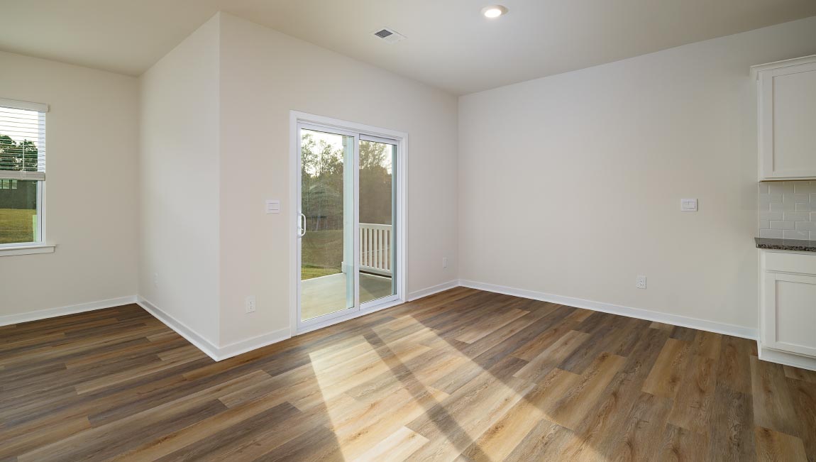 Kitchen and island with white cabinets and subway tiles and stainless steel subway tiles