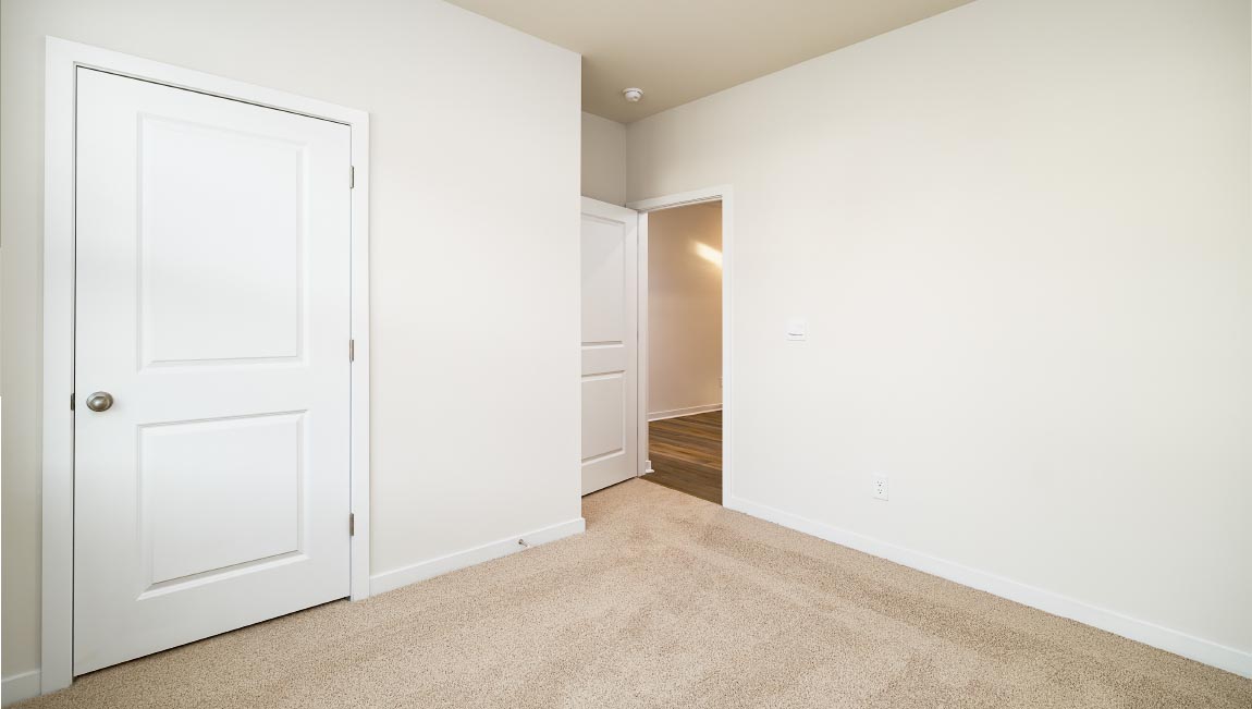 carpeted bedroom with large window