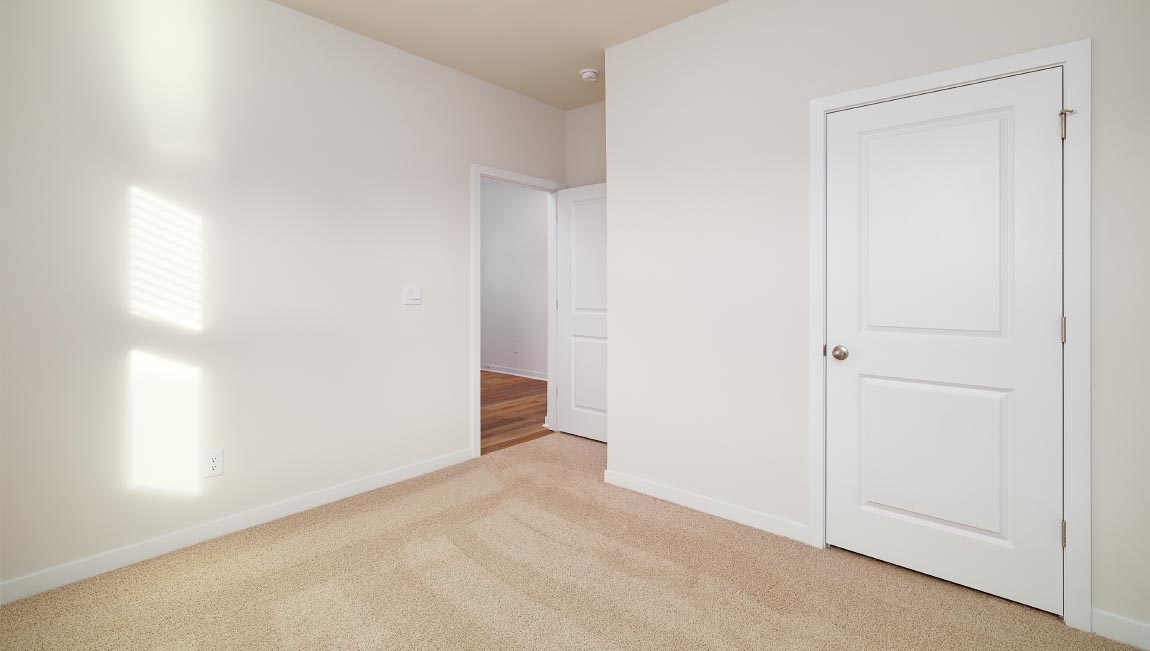 carpeted bedroom with large window