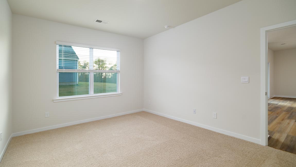 carpeted bedroom with large window