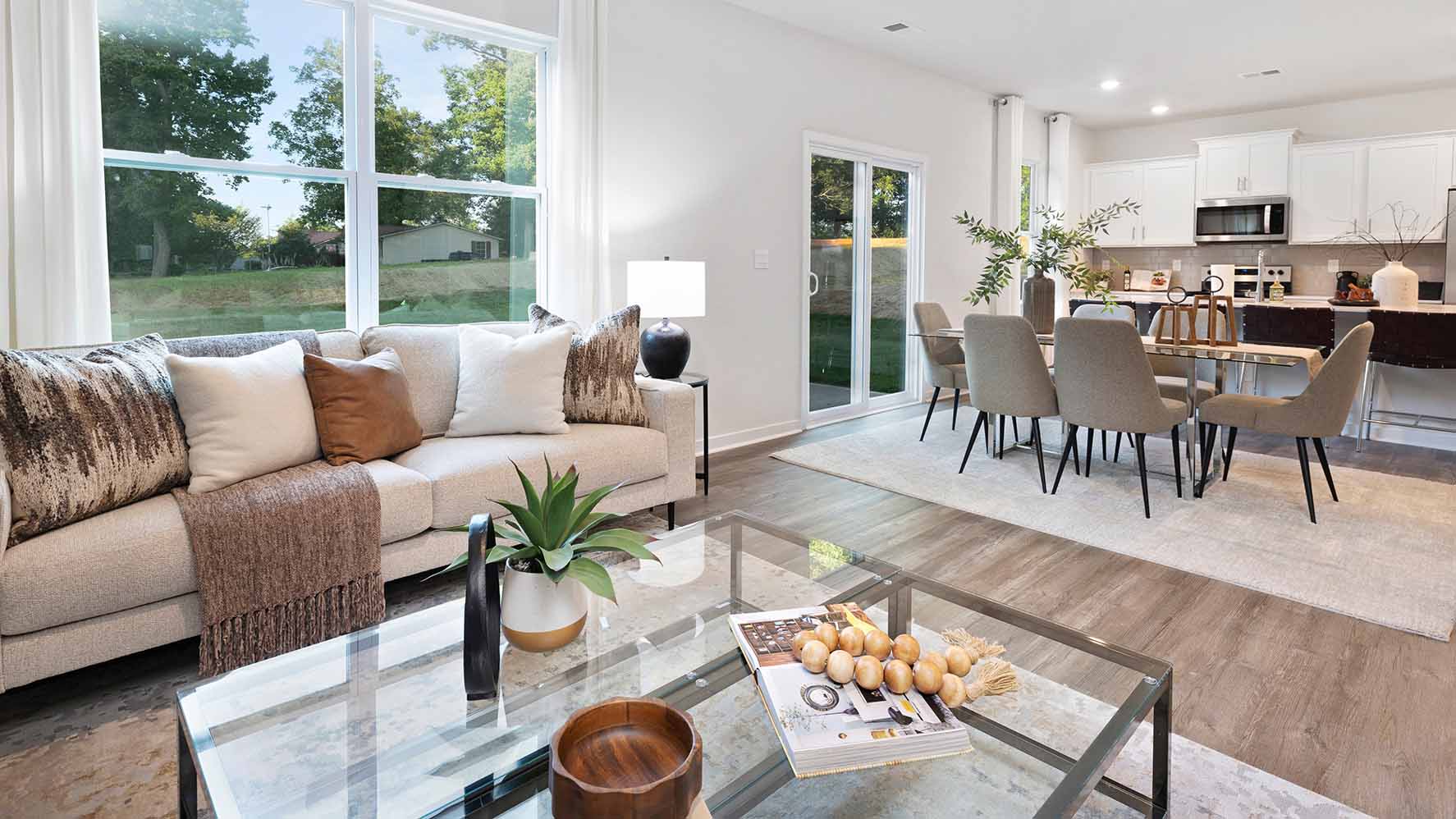 Living room with wood floors, fireplace and view of kitchen