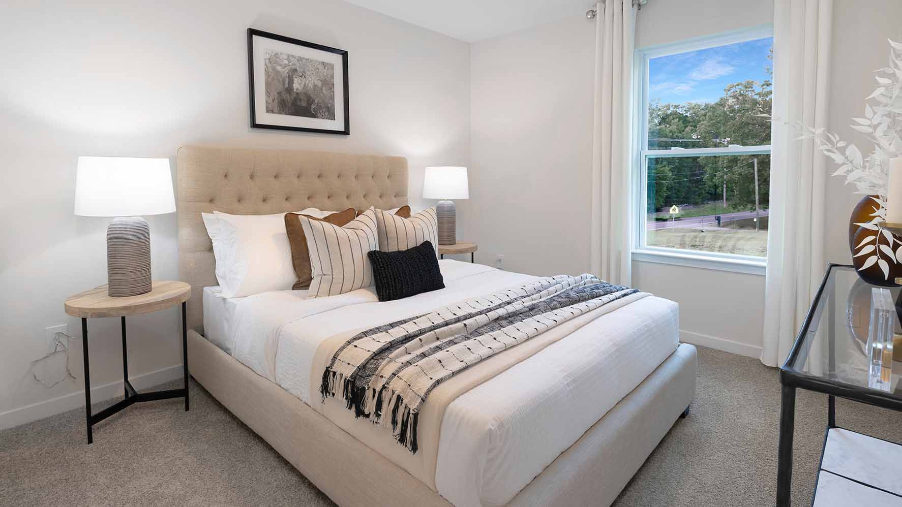 Carpeted bedroom with large window