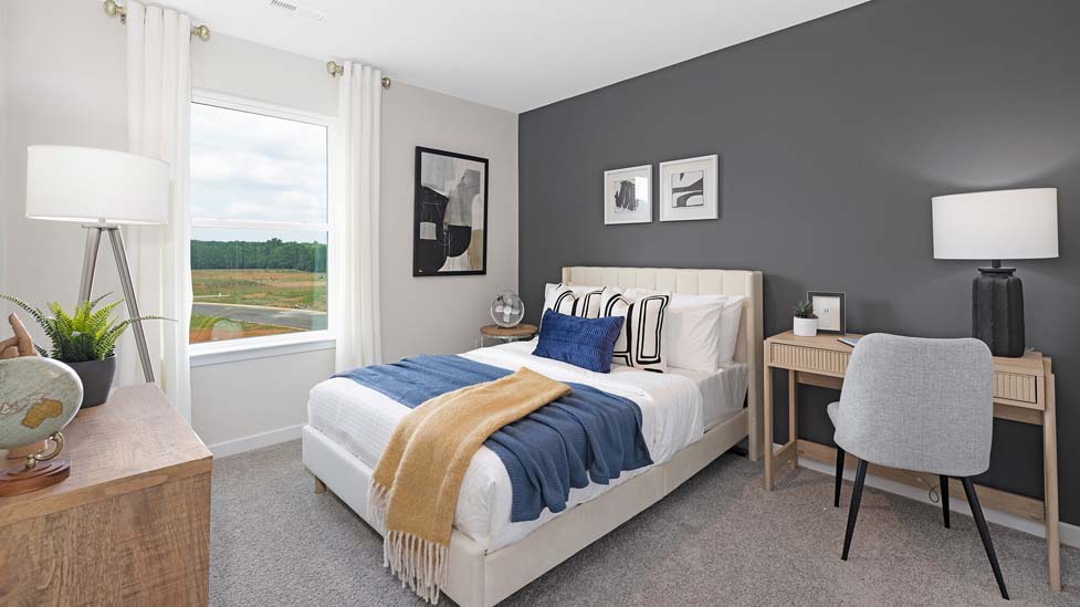 Carpeted bedroom with windows