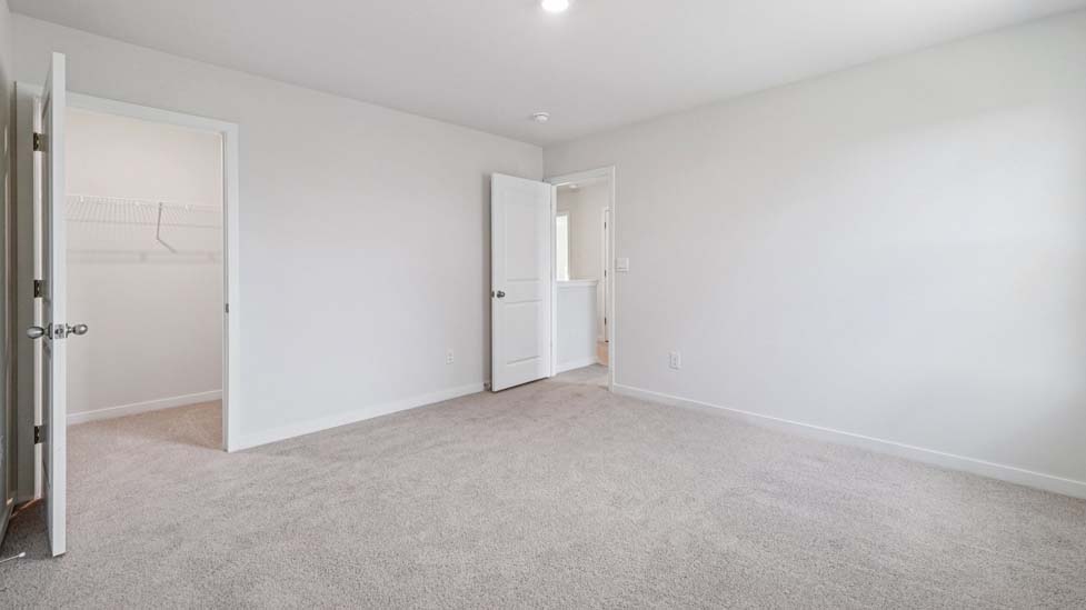 Bedroom carpeted with window