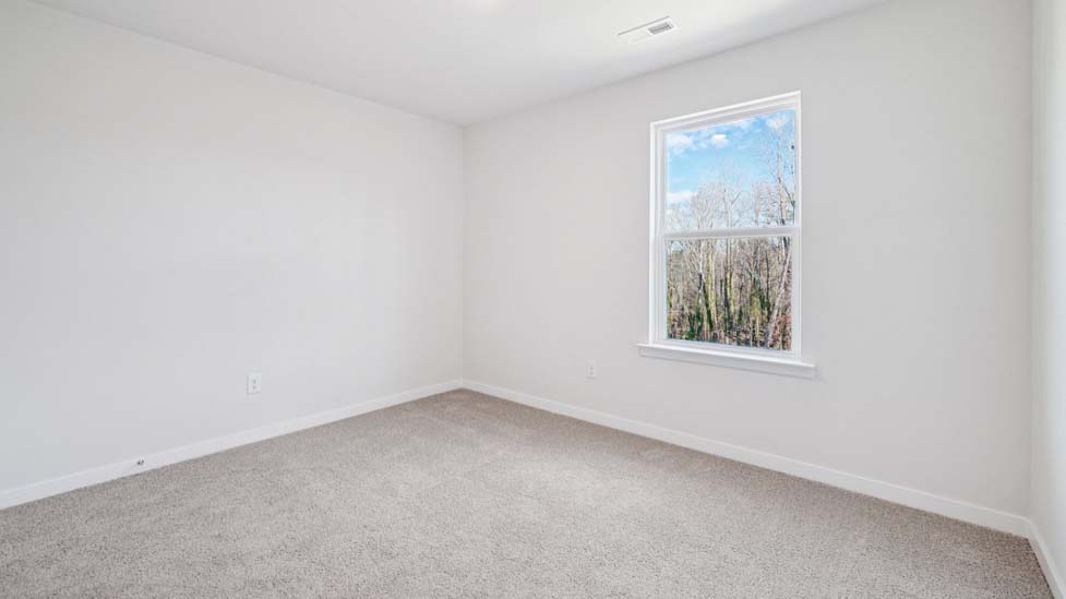 Bedroom carpeted with window