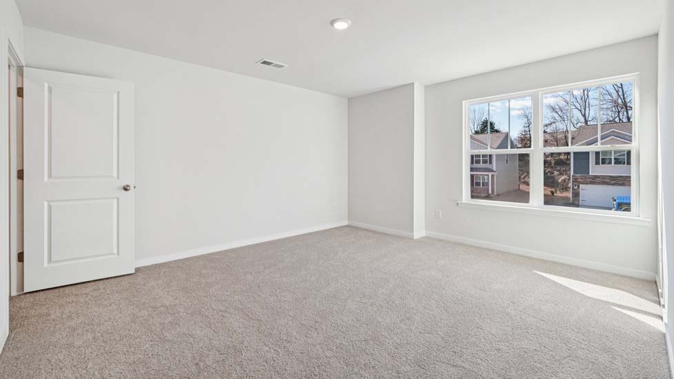 Bedroom carpeted with window