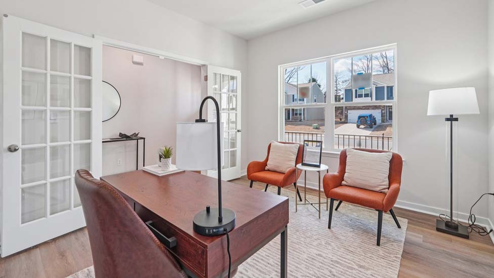 Flex office space with hardwood floors and large window