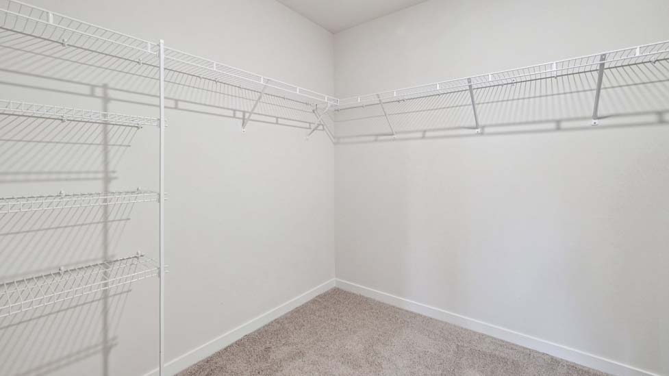 Primary bedroom walk in closet