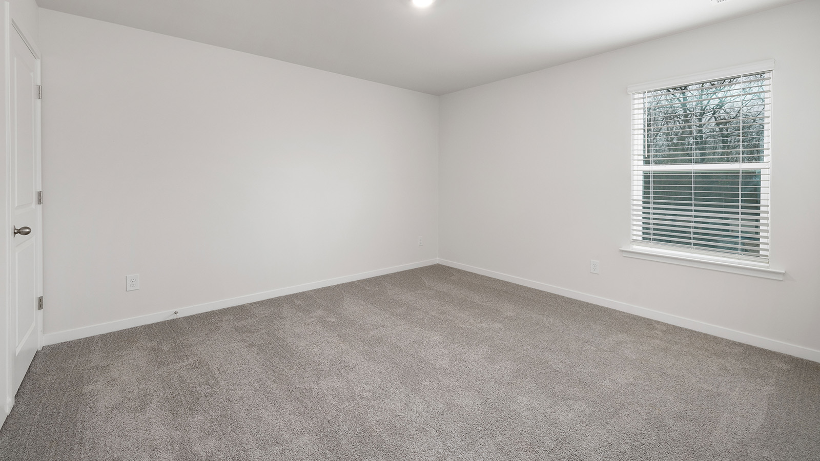 Bedroom carpeted with window