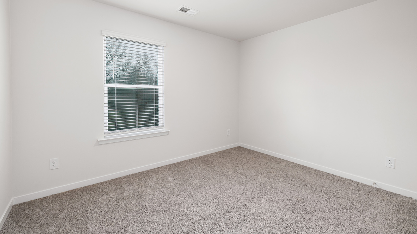 Bedroom carpeted with window