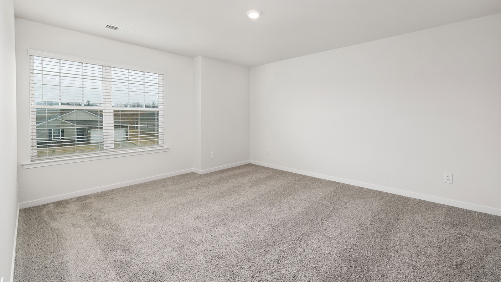 Bedroom carpeted with window
