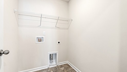 Laundry room with built in racks above machine space