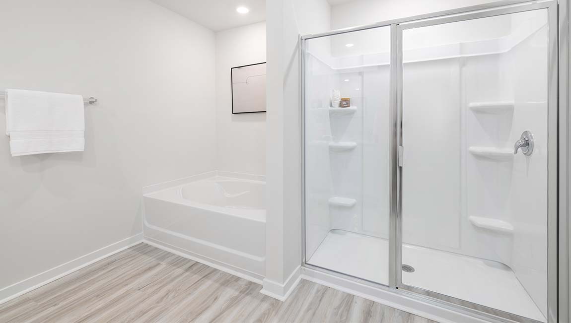 Primary bathroom with glass door shower, and bathtub