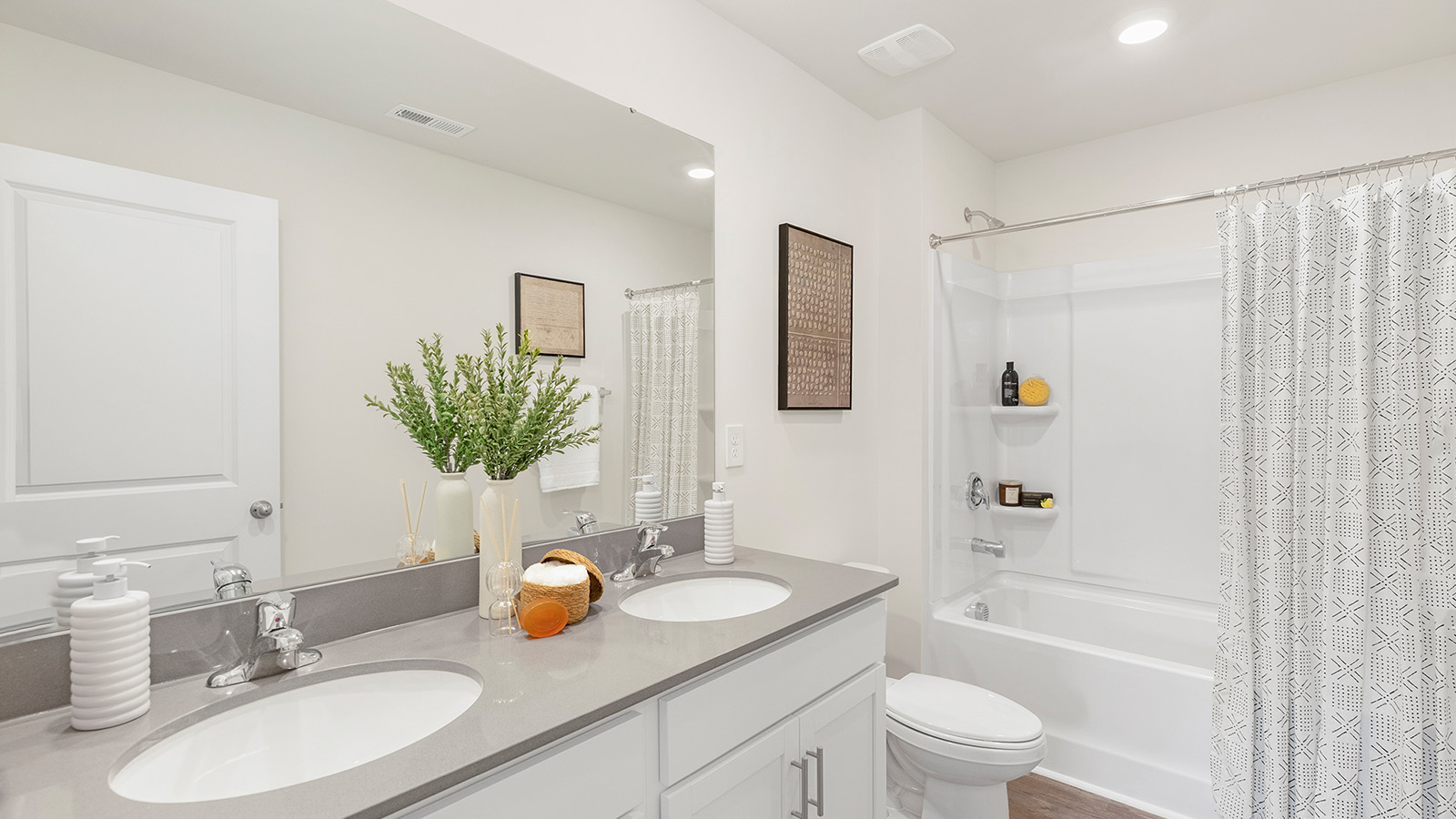 Bathroom with white cabinets and bathtub shower combination
