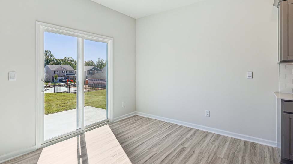 Breakfast area beside kitchen with large windows