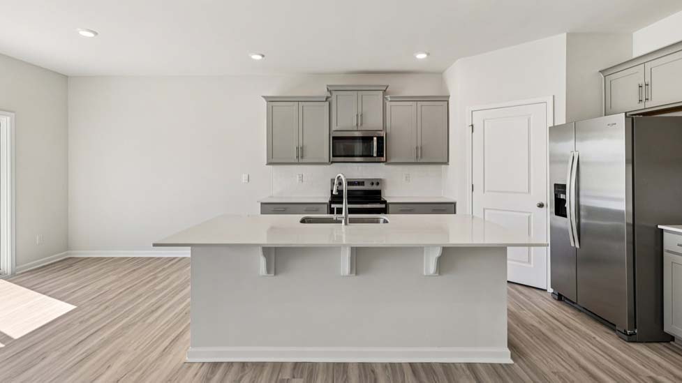 kitchen and island with stainless steel appliances