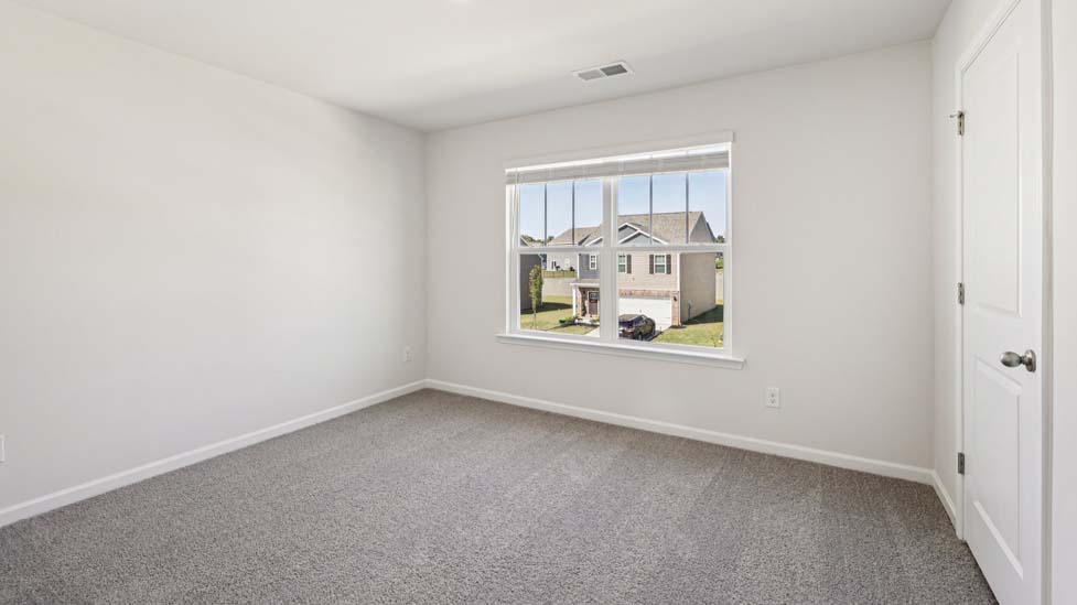 Carpeted bedroom with small window