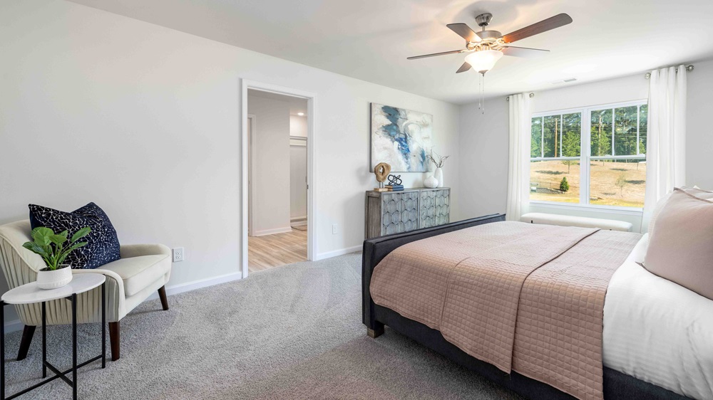 Primary bedroom with carpet and large windows