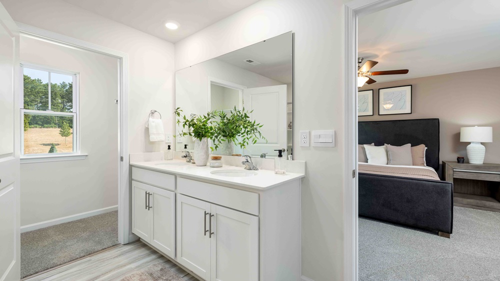 Primary bathroom with double sink vanity and large glass door shower