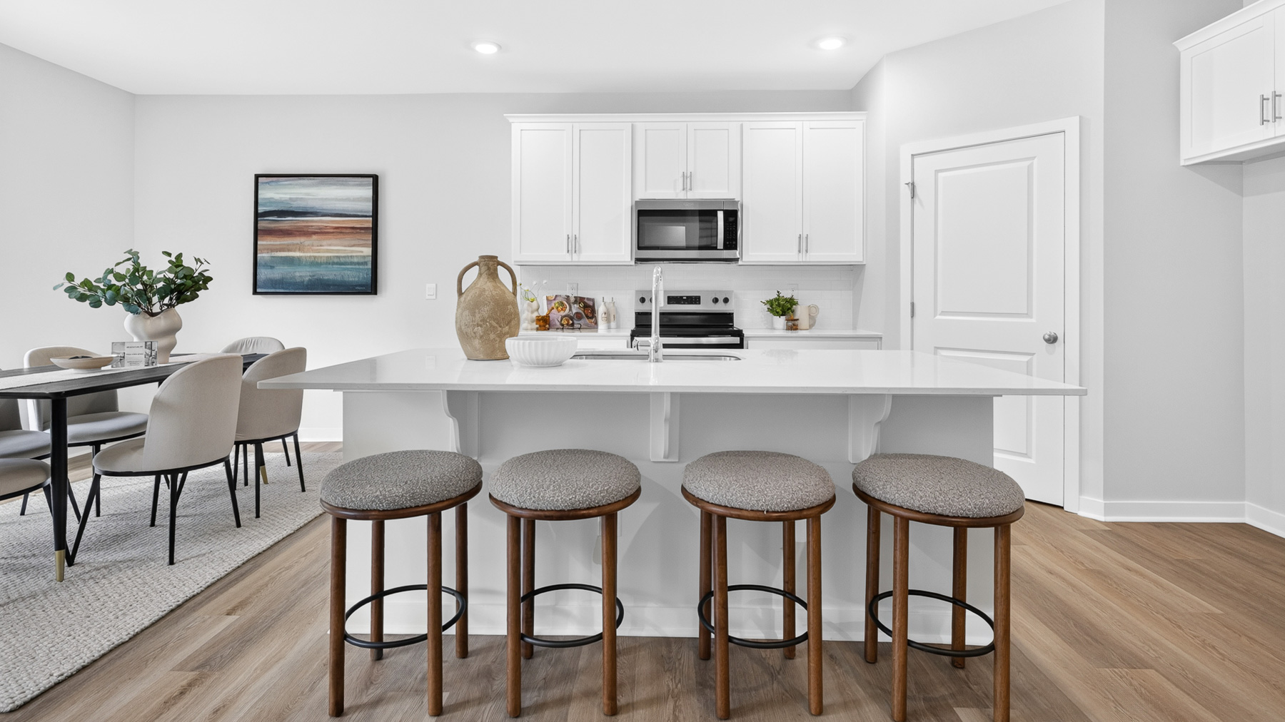 Kitchen and island with white cabinets