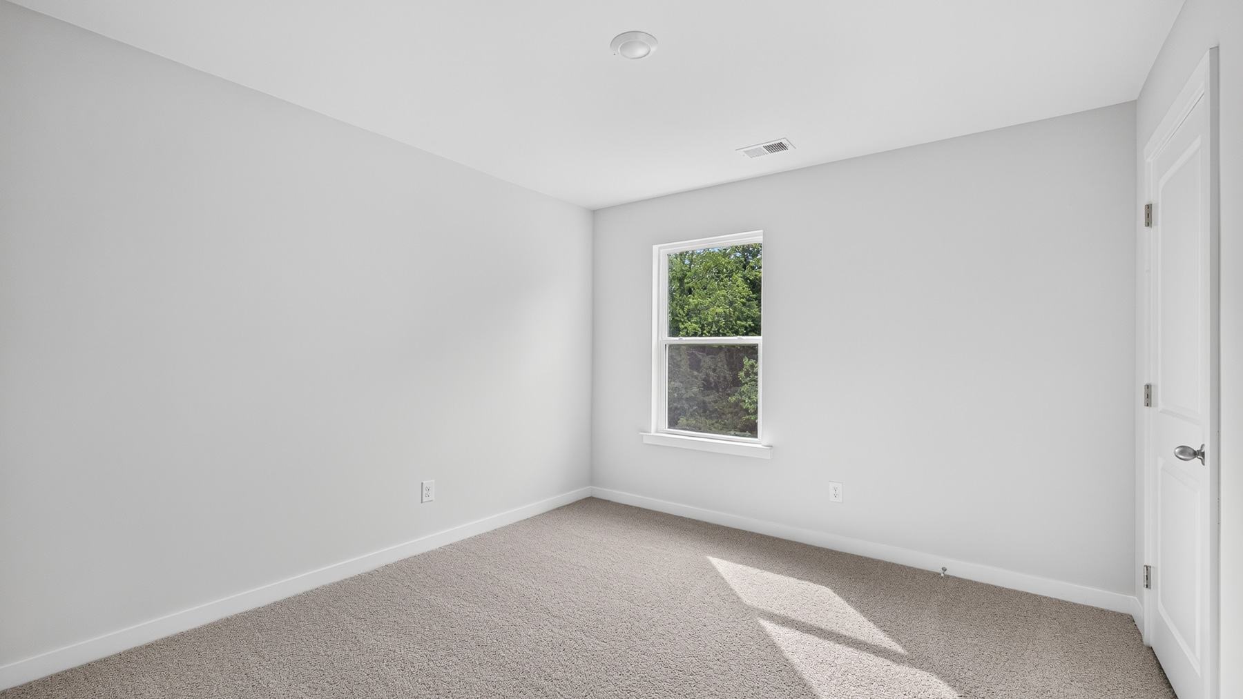 Carpeted bedroom with windows