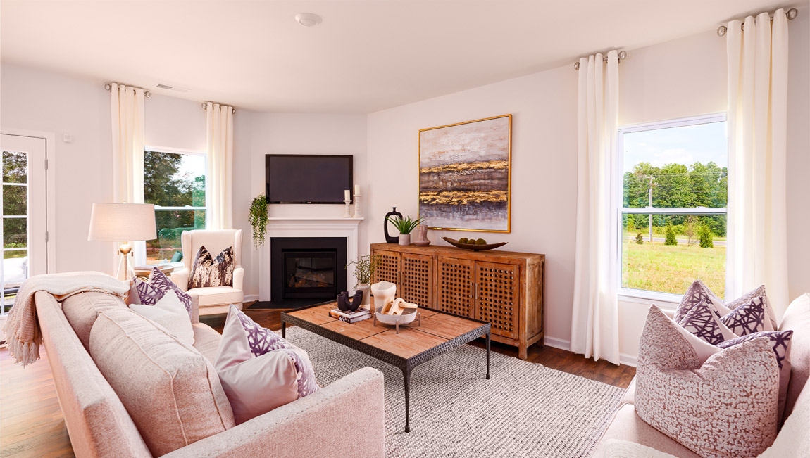 Open family room with fireplace and windows on either side