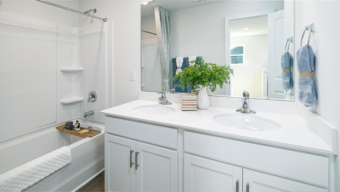 Primary bathroom with double sinks, and bathtub