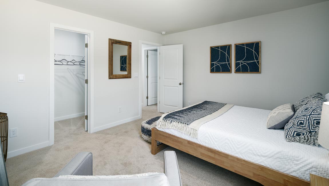 carpeted bedroom with two windows