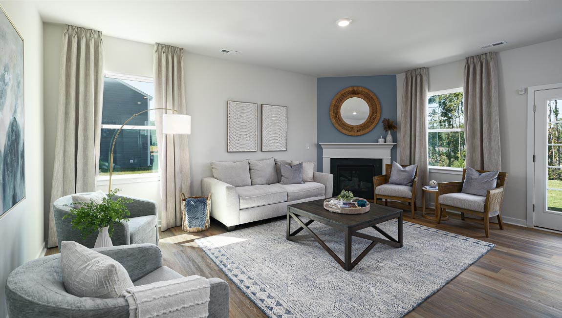 Open family room with fireplace and windows on either side