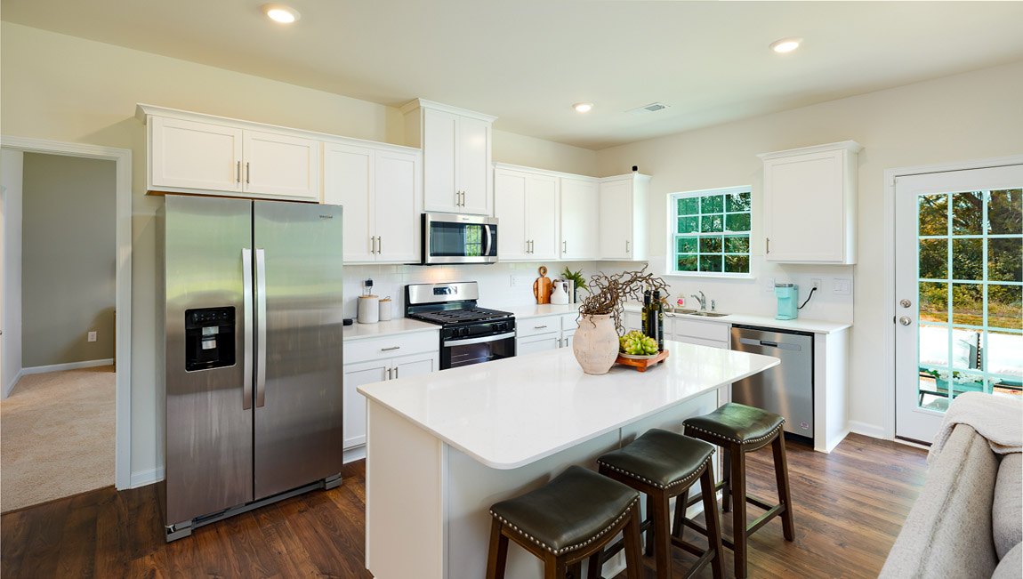 Kitchen and island with white counters and cabinets