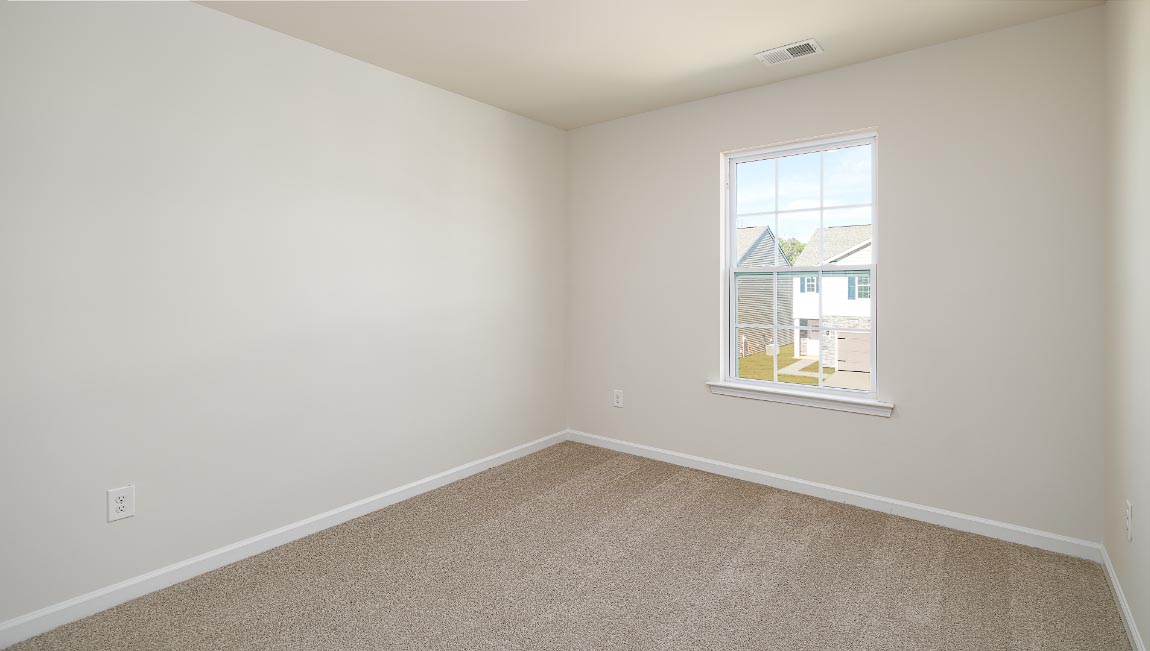 Carpeted bedroom with window