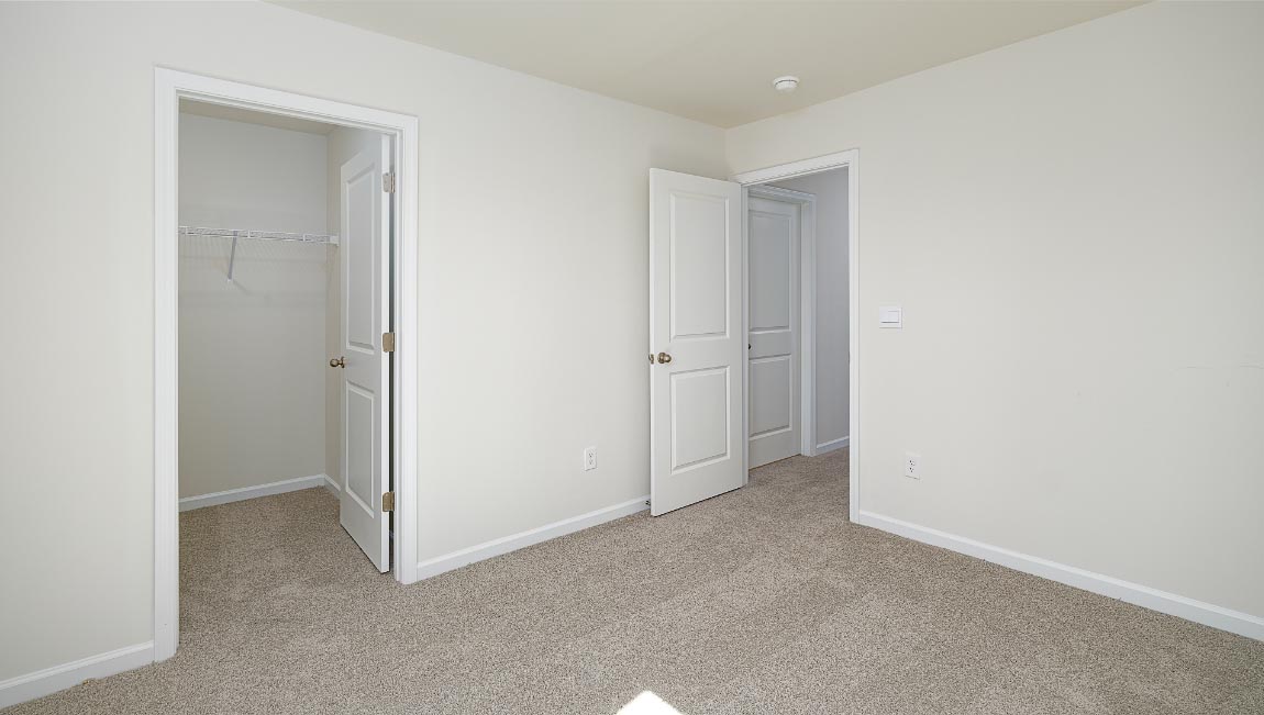Carpeted bedroom with window