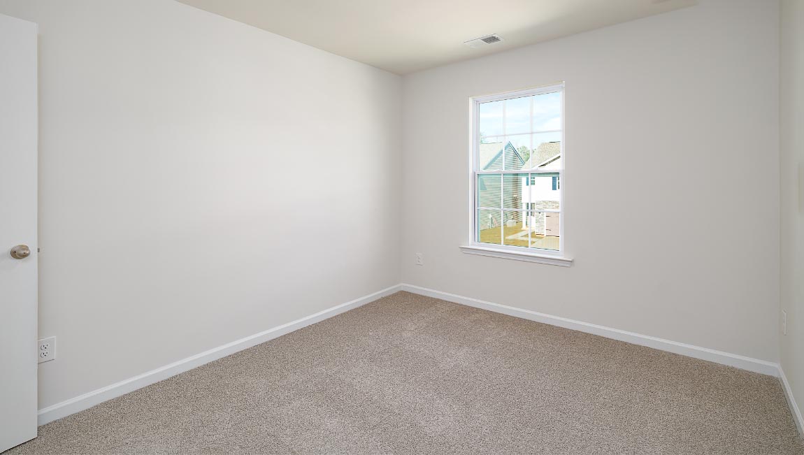Carpeted bedroom with window