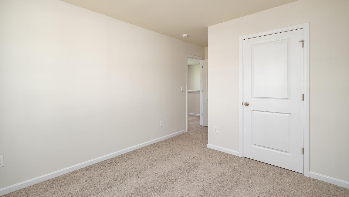 Carpeted bedroom with window