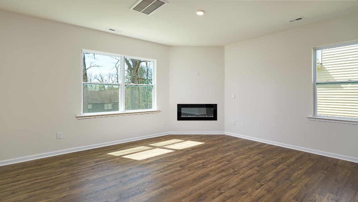 Spacious family room with large windows and fireplace