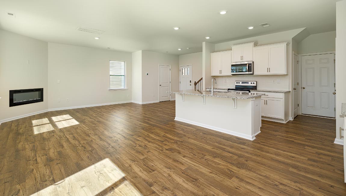 Spacious family room with large windows and fireplace