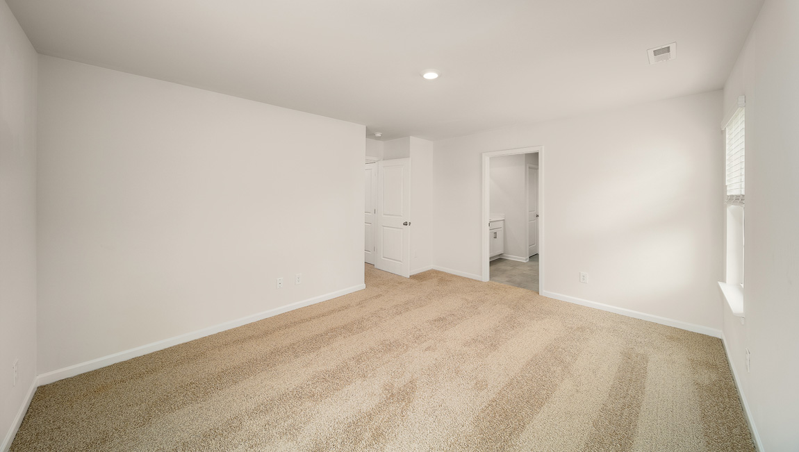 Primary bedroom, carpeted with large windows