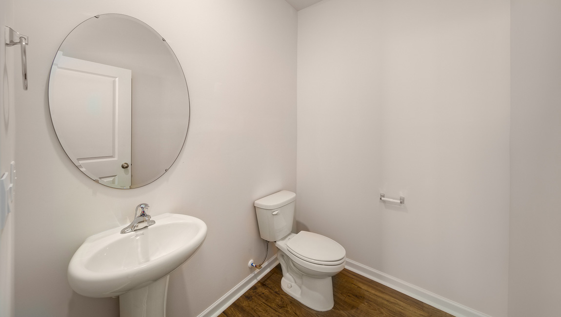 Powder bathroom with small sink and toilet