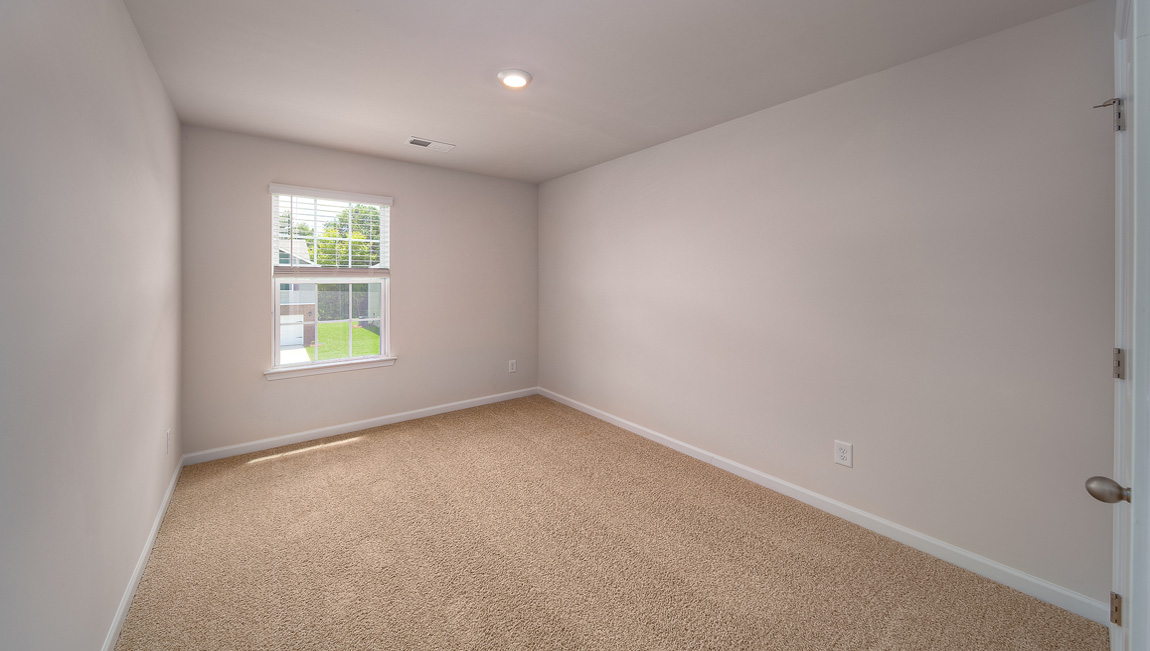 Carpeted bedroom with window