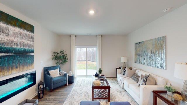 Living room featuring a white sofa, decorated in blue tones with a modern black fireplace