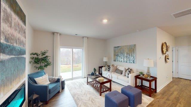 Living room featuring a white sofa, decorated in blue tones with a modern black fireplace