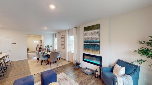 Living room featuring a white sofa, decorated in blue tones with a modern black fireplace
