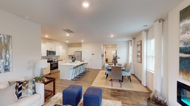 Living room featuring a white sofa, decorated in blue tones with a modern black fireplace