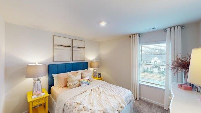Bedroom featuring a bed, decorated in dark blue tones with a large window