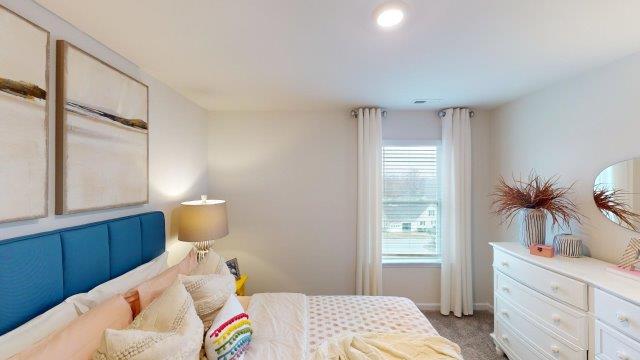 Bedroom featuring a bed, decorated in dark blue tones with a large window